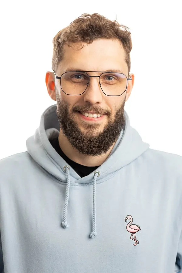 Adam Zdebel smiling in glasses and a light blue hoodie